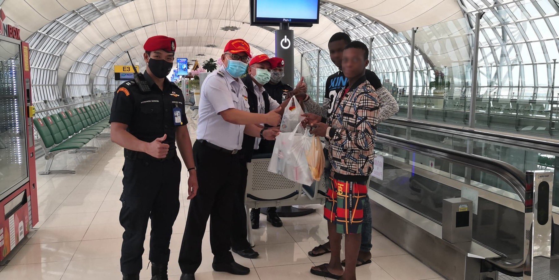 Three Nigerians stranded at a Thailand Airport.  Source: @RichardBarrow on Twitter.