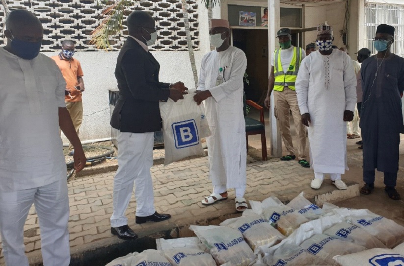 The Group Head, Media Relations Office of Julius Berger Plc, Prince Moses Duku, presents the JBN food palliatives to the AMAC Chairman, Hon. Abdullahi Adamu Candido in Abuja last Tuesday.